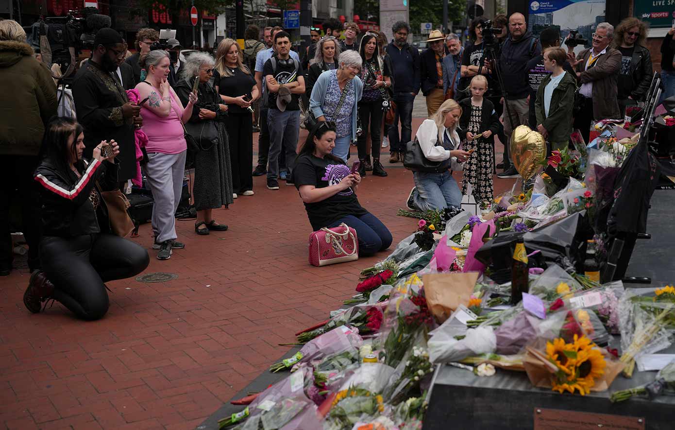 Flowers and messages are left by fans to commemorate the death of Ozzy Osbourne at the Black Sabbath Bridge in Birmingham