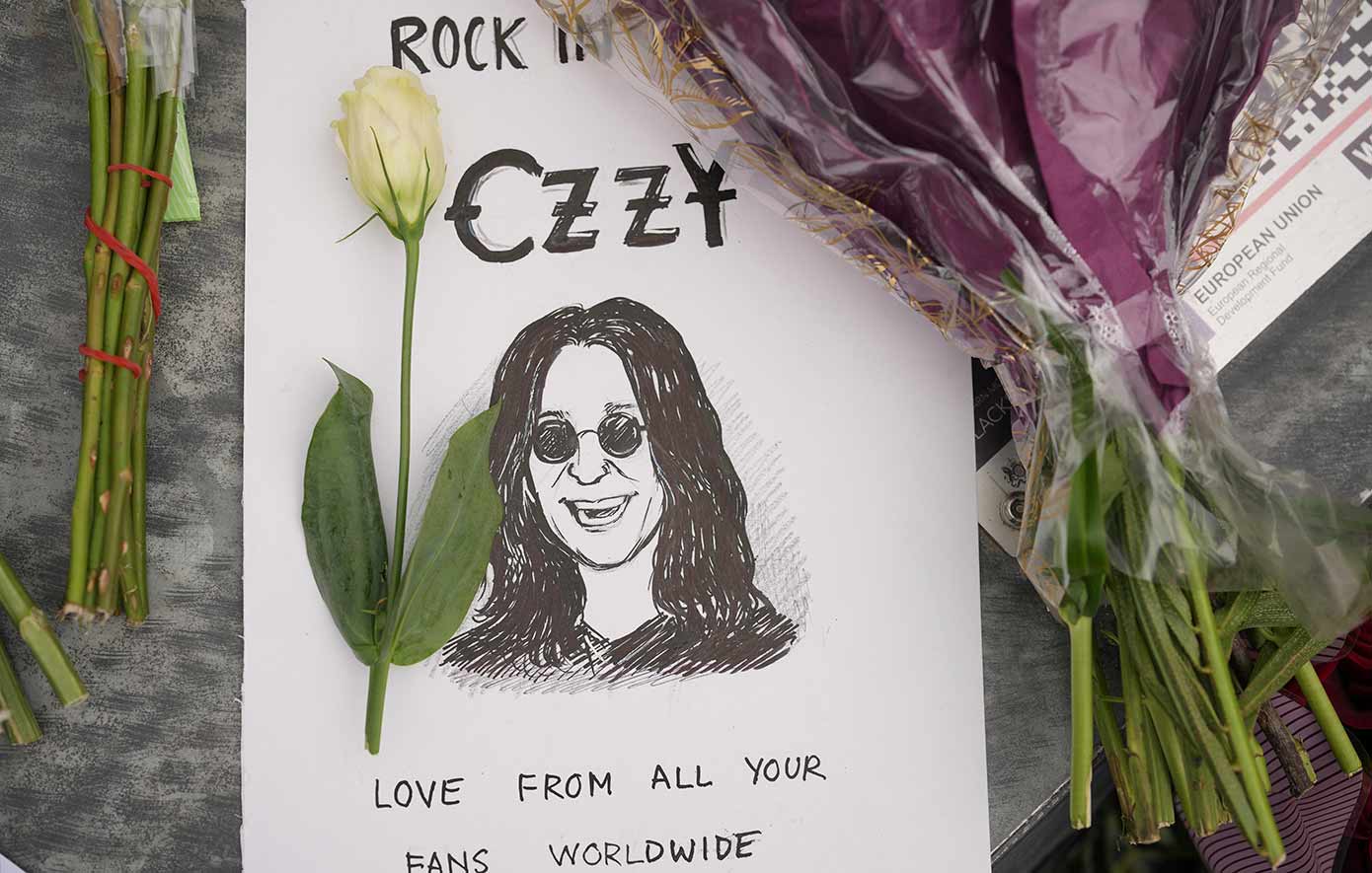 Flowers and messages are left by fans to commemorate the death of Ozzy Osbourne at the Black Sabbath Bridge in Birmingham
