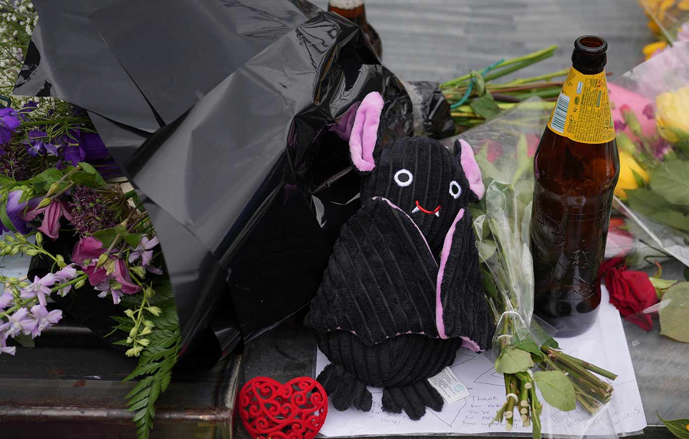 Flowers and messages are left by fans to commemorate the death of Ozzy Osbourne at the Black Sabbath Bridge in Birmingham