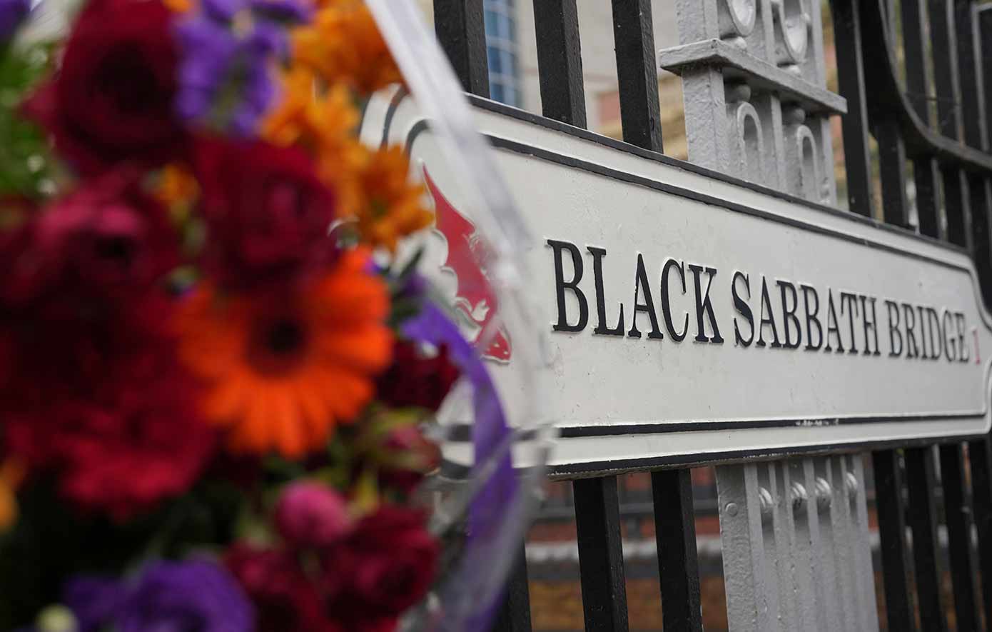 Flowers and messages are left by fans to commemorate the death of Ozzy Osbourne at the Black Sabbath Bridge in Birmingham