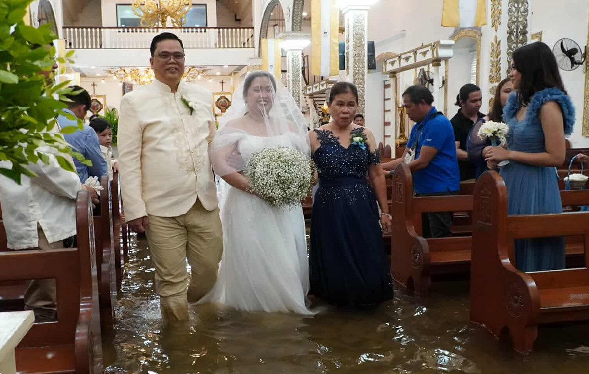 Grooms and brides in flooded churches – because the Philippians are doing “underwater” weddings