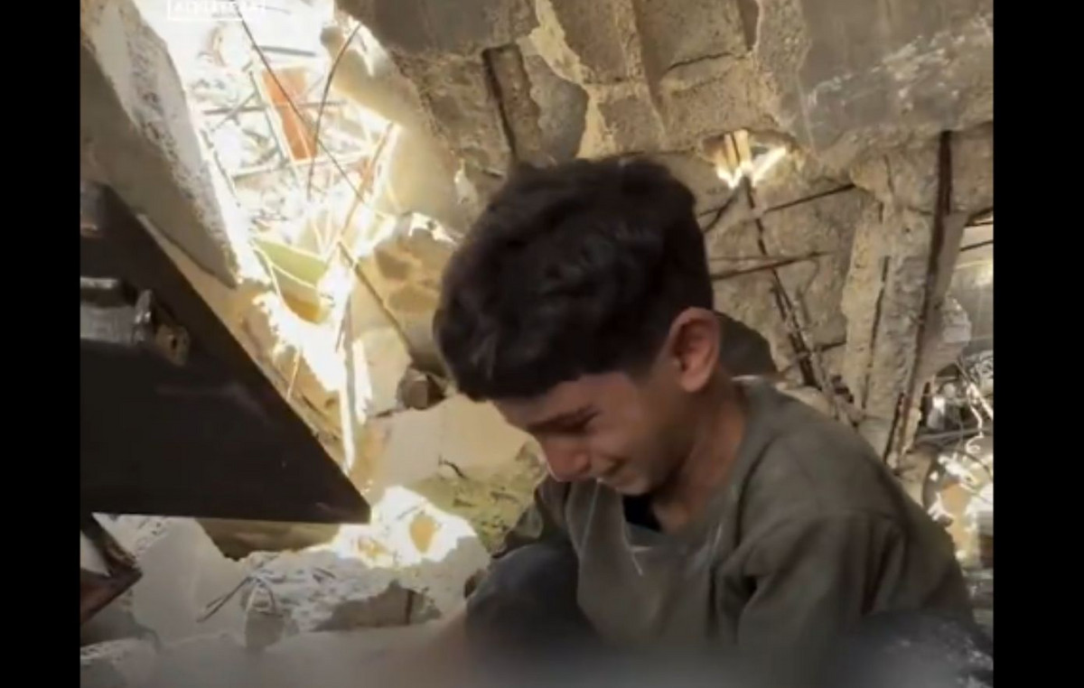 Growing up the Gaza Strip with a baby boy desperately looking for his grandmother and grandfather in debris