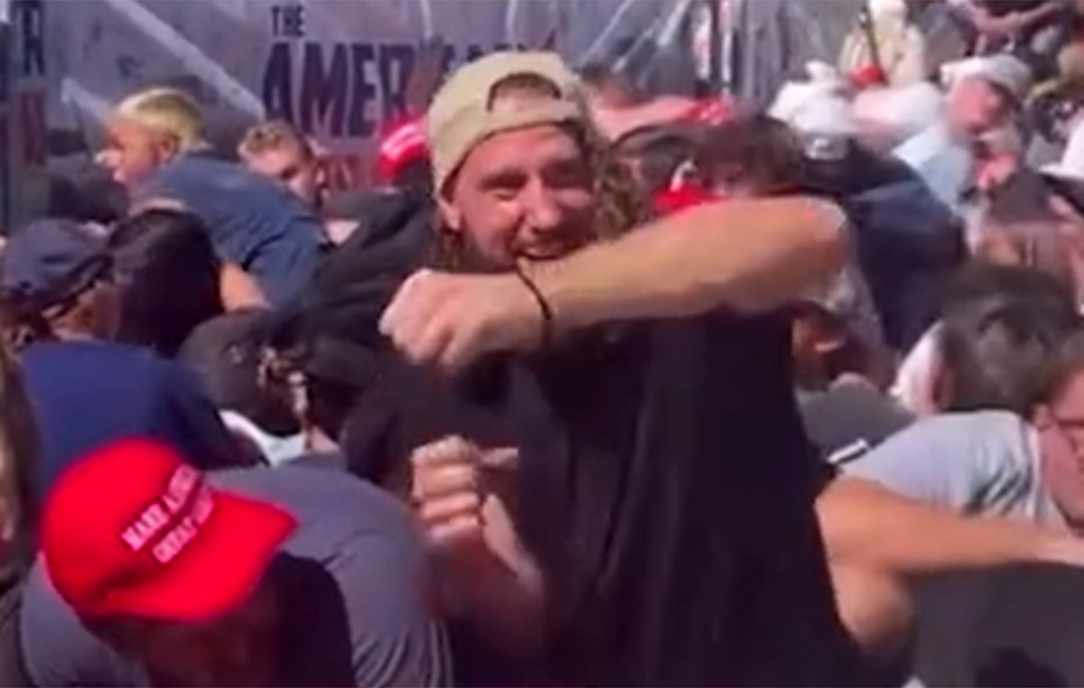 The mysterious man man in the crowd seems to celebrate after the murder of Charlie Kerk and looks back