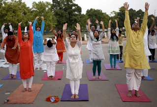 Participants perform a "Surya Namaskar" (sun salutation) during an early morning yoga session ahead of World Yoga Day, in New Delhi, India, June 13, 2015. World Yoga Day is celebrated on June 21. REUTERS/Anindito Mukherjee       TPX IMAGES OF THE DAY