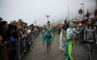 Participants take part in the Mermaid Parade along the boardwalk on Coney Island, in Brooklyn, New York, June 20, 2015. The annual parade, founded in 1983, seeks to bring mythology to life for residents, create confidence in the district and to allow artistic self-expression in public, according to the parade's website. REUTERS/Eduardo Munoz