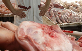 A butcher waits for customers at the central market in Athens, Greece, July 1, 2015. Greece's last-minute overtures to international creditors for financial aid on Tuesday were not enough to save the country from becoming the first developed economy to default on a loan with the International Monetary Fund.   REUTERS/Christian Hartmann