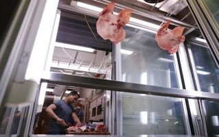 A butcher is seen at work at the central market in Athens, Greece, July 1, 2015. Greece's last-minute overtures to international creditors for financial aid on Tuesday were not enough to save the country from becoming the first developed economy to default on a loan with the International Monetary Fund.   REUTERS/Christian Hartmann