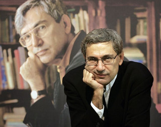 (FILES) Turkish author Orhan Pamuk poses in front of a poster showing himself 22 October 2005 during Frankfurt's international Book fair. Pamuk won the 2006 Nobel Literature Prize 12 October 2006, the Swedish Academy announced in Stockholm. AFP PHOTO   DDP/TORSTEN SILZ    GERMANY OUT GERMANY-TURKEY-NOBEL-LITERATURE-PAMUK GERMANY-TURKEY-NOBEL-LITERATURE-PAMUK