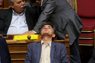 Greek Finance Minister Euclid Tsakalotos reacts during a parliamentary session in Athens, Greece July 15, 2015. A lot of the measures in a deal struck with Greece's lenders will have a recessionary effect but removing the prospect of a "Grexit" will help offset their impact and bring in investments, Tsakalotos said on Wednesday.   REUTERS/Yiannis Kourtoglou