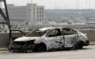 A damaged car is seen near the site of the explosions at the Binhai new district, Tianjin, August 13, 2015. At least 17 people were killed and 400 injured when two huge explosions tore through an industrial area where toxic chemicals and gas were stored in the northeast Chinese port city of Tianjin, state media said on Thursday. REUTERS/Jason Lee