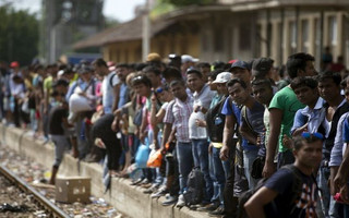 Migrants wait for a train to arrive at Gevgelija train station in Macedonia, close to the border with Greece, August 15, 2015. In the past month, an estimated 30,000 refugees have passed through Macedonia, another step in their uncertain search for a better life in western Europe.  REUTERS/Stoyan Nenov