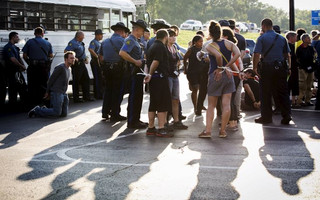 Officers from the St Louis County Police Department and the Missouri Highway Patrol process demonstrators from the "Black Lives Matter" movement in Earth City