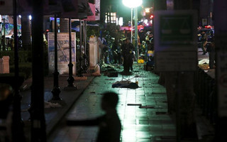 Security forces and emergency workers gather at the Erawan shrine, the site of a blast in central Bangkok August 17, 2015. The bomb planted at one of the Thai capital's most renowned shrines on Monday killed 16 people, including three foreign tourists, and wounded scores in an attack the government called a bid to destroy the economy. REUTERS/Chaiwat Subprasom