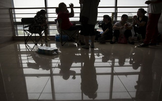 Friends and relatives of those injured in huge explosion at the port in Tianjin, China wait for further information at the intensive care unit of a hospital August 14, 2015. The blasts in the city of Tianjin on Wednesday night killed at least 50 people, including a dozen fire fighters, state media said. About 700 people were injured, 71 seriously. REUTERS/Damir Sagolj