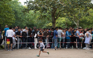 Newly arrived migrants wait in front of the State Office for Health and Social Affairs to apply for asylum in Berlin, Germany August 11, 2015. REUTERS/Stefanie Loos