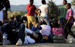 A new group of more than a thousand immigrants wait at the border line of Macedonia and Greece to enter into Macedonia