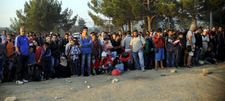 A new group of more than a thousand immigrants wait at the border line of Macedonia and Greece to enter into Macedonia