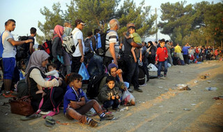 A new group of more than a thousand immigrants wait at the border line of Macedonia and Greece to enter into Macedonia