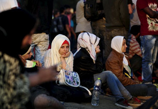 A new group of immigrants wait at the border line of Macedonia and Greece to enter into Macedonia