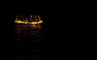 Migrants aboard a dinghy sail off for the Greek island of Kos from the southern Turkish coastal town of Bodrum