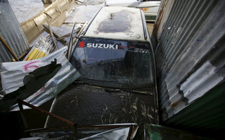 A car is partially submerged by floodwaters flowing from the swollen Bagmati River caused by heavy rainfall, in Kathmandu