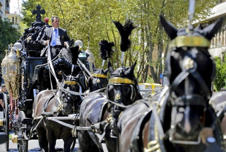 An ornate hearse pulled by six, black-plumed horses, carries the body of Vittorio Casamonica to a Roman Catholic basilica in the Rome suburbs, where the funeral mass was celebrated, August 20, 2015. Casamonica, 65, the head of a notorious Rome crime family, was given a lavish funeral on Thursday, with a helicopter dropping red rose petals on mourners and a brass band playing the theme tune from the Godfather movie. Picture taken August 20, 2015. REUTERS/Stringer