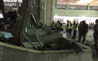Members of a Saudi emergency crew stand near damage caused by a collapsed crane in the Grand Mosque in the Muslim holy city of Mecca, Saudi Arabia in this handout picture published on Twitter account of the Directorate of the Saudi Civil Defense September 11, 2015. At least 107 people were killed when the crane toppled over at Mecca's Grand Mosque on Friday, Saudi Arabia's Civil Defence authority said, less than two weeks before Islam's annual haj pilgrimage. REUTERS/Directorate of the Saudi Civil Defense/Handout via ReutersATTENTION EDITORS - THIS IMAGE HAS BEEN SUPPLIED BY A THIRD PARTY. IT IS DISTRIBUTED, EXACTLY AS RECEIVED BY REUTERS, AS A SERVICE TO CLIENTS. REUTERS IS UNABLE TO INDEPENDENTLY VERIFY THE AUTHENTICITY, CONTENT, LOCATION OR DATE OF THIS IMAGE. FOR EDITORIAL USE ONLY. NOT FOR SALE FOR MARKETING OR ADVERTISING CAMPAIGNS. NO SALES.