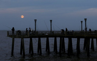 A supermoon rises in the sky over the Rio de La Plata in Buenos Aires