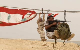 Members of the Lebanese Army's airborne regiment perform a live drill, held as part of a weapons exhibition during the Security Middle East Show in Beirut