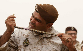 A member of the Lebanese Army's airborne regiment eats snakes during a live drill, held as part of a weapons exhibition during the Security Middle East Show in Beirut