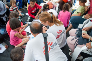 MSF psychologist Lena Zachou works together with Bashir a translator from Afghanistan at a programme set up for refugee children at the port of Mytiline.