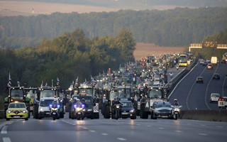 French farmers from western France regions drive their tractors on the A10 motorway outside Paris