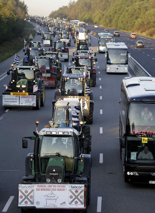 French farmers from western France regions drive their tractors on the A10 motorway outside Paris