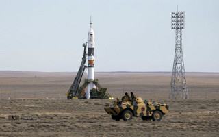 An armoured personnel carrier (APC) drives in front of the Soyuz TMA-18M spacecraft shortly before the launch with the international crew at the Baikonur cosmodrome, Kazakhstan, September 2, 2015.  REUTERS/Shamil Zhumatov