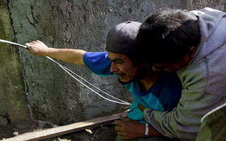 A relative of a mudslide victim is comforted by a friend in Santa Catarina Pinula, on the outskirts of Guatemala City, October 2, 2015. Hundreds of rescue workers dug through sludge and rock on Friday looking for survivors of a massive mudslide in Guatemala that killed at least nine people and left as many as 600 missing, burying homes in a town on the edge of the capital. Heavy rains swept a torrent of boulders and mud over dozens of homes on Thursday night in Santa Catarina Pinula on the southeastern flank of Guatemala City, one of the worst mudslides to hit the poor Central American country in recent memory. REUTERS/Josue Decavele