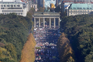 Consumer rights activists take part in a march to protest against the Transatlantic Trade and Investment Partnership (TTIP), mass husbandry and genetic engineering, in Berlin, Germany, October 10, 2015. The European Union is pursuing a trade accord with the United States, called the Transatlantic Trade and Investment Partnership (TTIP), that would encompass a third of world trade and nearly half of global GDP. In background is the Brandenburg Gate.        REUTERS/Fabrizio Bensch