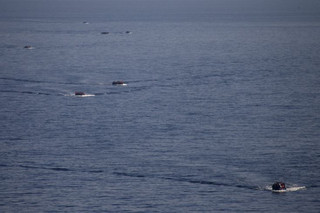 Refugees and migrants are seen onboard dinghies as they cross a part of the Aegean Sea from the Turkish coast to reach the Greek island of Lesbos, October 4, 2015. Refugee and migrant arrivals to Greece this year will soon reach 400,000, according to the UN Refugee Agency (UNHCR). REUTERS/Dimitris Michalakis