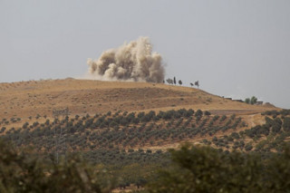 Smoke rises after what activists said were air strikes carried out by the Russian air force on Talat al-Sayyad, in the northern countryside of Hama, Syria October 14, 2015. Supported by two weeks of air strikes, the Syrian army and its allies have been fighting insurgents in northern Hama province, and neighbouring Idlib and Latakia provinces, trying to reverse rebel gains over the summer which had threatened the coastal heartlands of Assad's Alawite minority. REUTERS/Khalil Ashawi