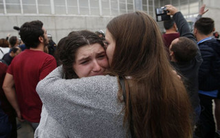 A woman cries after civil guards dragged people away from the entrance of a sports center, assigned to be a referendum polling station by the Catalan government in Sant Julia de Ramis, near Girona, Spain, Sunday, Oct. 1, 2017. Scuffles have erupted as voters protested as dozens of anti-rioting police broke into a polling station where the regional leader was expected to show up for voting on Sunday. (AP Photo/Francisco Seco)