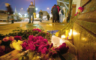 Flowers lie at the site of an explosion at the National Hotel in downtown Moscow, Wednesday, Dec. 10, 2003. A female suicide bomber set off an explosion outside the National Hotel across from Moscow's Red Square on Tuesday, killing five people and herself, wounding at least 12 and sparking fears of a new wave of terrorist attacks in the heart of the Russian capital. (AP Photo/Mikhail Metzel)