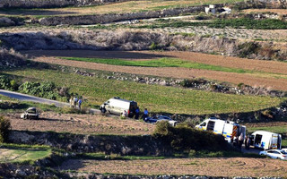 An ambulance and police vehicles are parked along the road where a car bomb exploded killing investigative journalist Daphne Caruana Galizia, in the town of Mosta, Malta, Monday, Oct. 16, 2017. Malta's prime minister says a car bomb has killed an investigative journalist on the island nation. Prime Minister Joseph Muscat said the bomb that killed reporter Daphne Caruana Galizia exploded Monday afternoon as she left her home in a town outside Malta's capital, Valetta. (AP Photo/Rene Rossignaud)