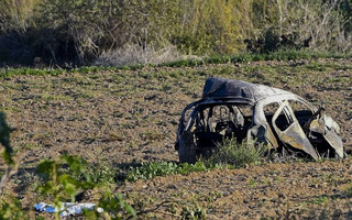 The wreckage of the car of investigative journalist Daphne Caruana Galizia lies next to a road in the town of Mosta, Malta, Monday, Oct. 16, 2017. Malta's prime minister says a car bomb has killed an investigative journalist on the island nation. Prime Minister Joseph Muscat said the bomb that killed reporter Daphne Caruana Galizia exploded Monday afternoon as she left her home in a town outside Malta's capital, Valetta. (AP Photo/Rene Rossignaud)