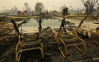 Fire burns from an open gas valve near the pool area at the Journey's End mobile home park on Monday, Oct. 9, 2017, in Santa Rosa, Calif. Wildfires whipped by powerful winds swept through Northern California early Monday, sending residents on a headlong flight to safety through smoke and flames as homes burned. (AP Photo/Ben Margot)