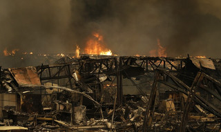 Fire continues to burn at Keysight Technologies Monday afternoon, Oct. 9, 2017, in Santa Rosa, Calif. Wildfires whipped by powerful winds swept through Northern California early Monday, sending residents on a headlong flight to safety through smoke and flames as homes burned. (AP Photo/Ben Margot)