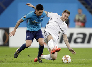 Zenit's Matias Kranevitter, left, fights for the ball with Rosenborg's Nicklas Bendtner during a Europa League group L soccer match between Zenit St. Petersburg and Rosenborg BK at the Saint Petersburg stadium in St. Petersburg, Russia, Thursday, Oct. 19, 2017. (AP Photo/Dmitri Lovetsky)