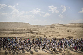 Israeli and Palestinian women participate in a march organized by the "Women Wage Peace" organization, near the Dead Sea, Sunday, Oct. 8, 2017. Thousands of women are wrapping up the march around the region, demanding that their leaders act to achieve a peace agreement. “The group says the two-week march sends a message to their leaders to work toward a negotiated solution to the Israeli-Palestinian conflict and to make sure women have equal representation in any talks. (AP Photo/Sebastian Scheiner)