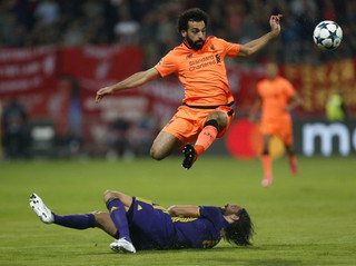 Liverpool's Mohamed Salah, top, duels for the ball with Maribor's Marko Suler during the Champions League soccer match between Maribor and Liverpool at the Ljudski vrt stadium, in Maribor, Slovenia, Tuesday, Oct. 17, 2017. (AP Photo/Darko Bandic)
