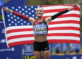 Shalane Flanagan of the United States poses for pictures after crossing the finish line first in the women's division of the New York City Marathon in New York, Sunday, Nov. 5, 2017. (AP Photo/Seth Wenig)