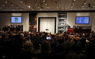 CORRECTS PRICE - Christie's auctioneer Jussi Pylkannen, third from right, looks for another bid for Leonardo da Vinci's "Salvator Mundi" at Christie's, Wednesday, Nov. 15, 2017, in New York. The painting sold at $450 million. (AP Photo/Julie Jacobson)