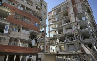 Buildings are damaged by an earthquake in a compound which was built under the Mehr state-owned program, in Sarpol-e-Zahab in western Iran, Tuesday, Nov. 14, 2017. Iran's President Hassan Rouhani says his administration will probe the cause of so much damage to buildings constructed under the Mehr program after a powerful earthquake hit the area along the border with Iraq on Sunday which killed over 400 people. (AP Photo/Vahid Salemi)